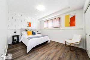 埃德蒙顿Chic Modern Vibes - Sleeps 6 - Netfix - Wifi - Long Stays的一间带床和椅子的白色卧室