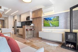 TV a/nebo společenská místnost v ubytování Loft Canela 1 Suíte Centro by Achei