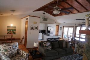 a living room with a couch and a kitchen at Entire 3 Bedroom Home in Rumbling Bald Resort in Lake Lure