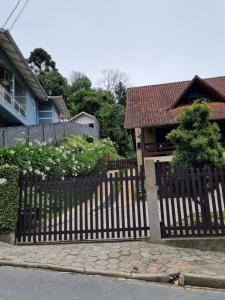 a wooden fence in front of a house at Chalé JS in São Bento do Sul