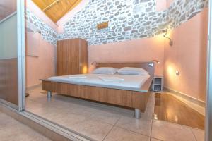 a bedroom with a large bed in a room at House Dinko in Bol