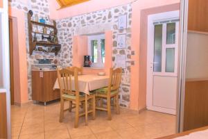 a dining room with a table and two chairs at House Dinko in Bol
