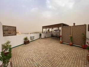an outdoor patio with potted plants on a building at Dar Bouzoubaa in Fez +15 photos