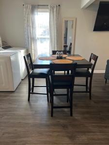 a dining room with a table and chairs and a kitchen at The Central Crib in Kansas City