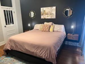 een slaapkamer met een bed met twee spiegels aan de muur bij Masseys on Grove Unit B in Vicksburg