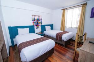 A bed or beds in a room at Inkarri Cusco