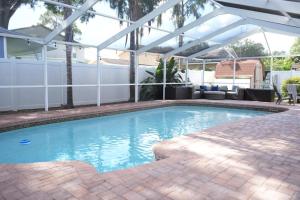 una gran piscina con una pérgola blanca en Hosting new, en Tampa
