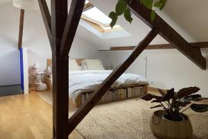 a bedroom with a bed and a tree in it at Spacious 70 m renovated duplex family home in Suresnes