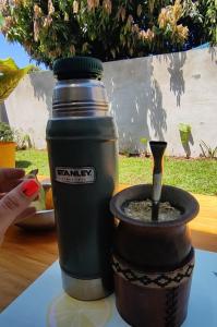 a drink bottle sitting on top of a table at La Rosadita House in Jardín América