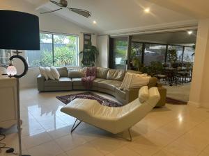 a living room with a couch and a chair at Whitfords Delight Homestay in Perth