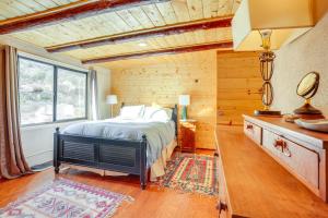 a bedroom with a bed and a large window at Peaceful Historic Cottage on Sedona Wine Trail in Cottonwood