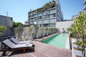 an apartment patio with a swimming pool and a building at Dazzler by Wyndham Buenos Aires Palermo in Buenos Aires