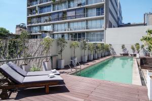 a hotel with a swimming pool and a building at Dazzler by Wyndham Buenos Aires Palermo in Buenos Aires