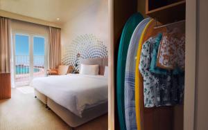a hotel room with a bed and a surfboard at Rove La Mer Beach, Jumeirah in Dubai