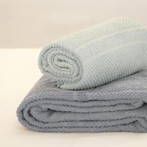 a pile of towels sitting on a table at Shark's Lodge in Baleal