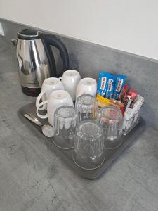a tray with cups and other items on a counter at Willa Vistula in Ciechocinek