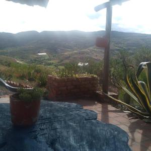 a stone patio with a view of a mountain at Apartamento campestre in Villa de Leyva