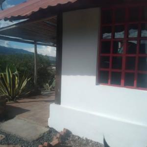 a window of a house with a view of the mountains at Apartamento campestre in Villa de Leyva
