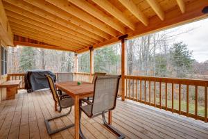 a wooden deck with a table and chairs on it at Expansive Wilmot Escape with Deck Near Skiing! in Wilmot