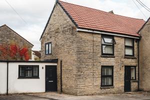 a brick house with a red roof at Wych Cottage, Striking 2 Bed, Parking, Ground Floor Flat - Step Free in Somerton