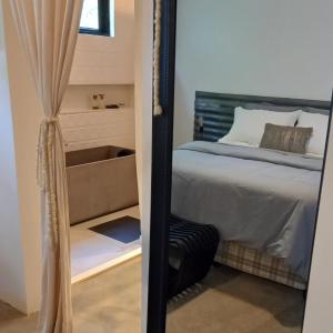 a bedroom with a bed and a mirror at Pousada IMcasa 430 in Bento Gonçalves