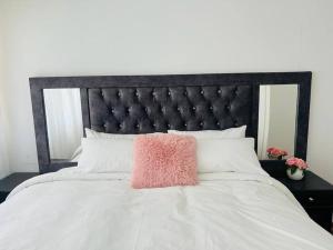 a pink pillow sitting on top of a bed at Villa Le Rosa Unit 2 in Durban