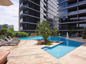 a swimming pool in front of a tall building at Artistic South Brisbane 2 bedroom Apartment with Parking in Brisbane