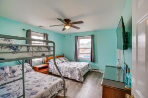 a bedroom with two bunk beds and a ceiling fan at Beach House with Private Pool in North Wildwood in North Wildwood
