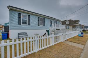 a blue house with a white picket fence at Beach House with Private Pool in North Wildwood in North Wildwood