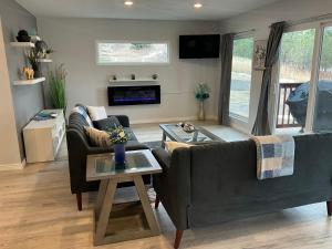 a living room with two couches and a fireplace at Luxury home in the nature in Gleneagle