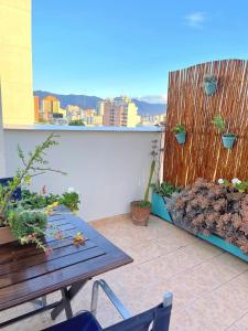 einen Balkon mit einem Holzzaun und einem Holztisch in der Unterkunft Encantador Dpto, ubicación Única! Paga en pesos! in Salta