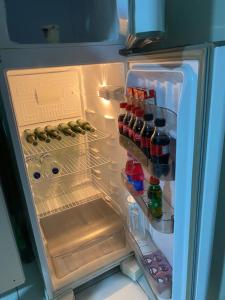 an open refrigerator filled with lots of drinks at Edifício Creta in São Luís