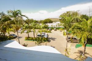 an aerial view of a parking lot with palm trees at Hideaway Hotel in Port Moresby