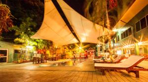 a large umbrella hanging over a swimming pool at night at Hideaway Hotel in Port Moresby