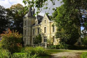 an old house with a tower on top of it at Apartment in Bénodet near Sandy Beaches in Bénodet