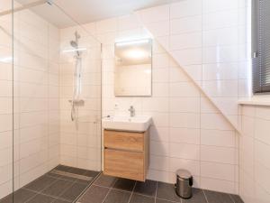a bathroom with a sink and a shower at holiday home in Scherpenisse with sauna in Scherpenisse +32 photos