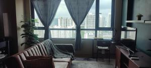 a living room with a couch and a large window at Kory Homes Relax in Cyberjaya +6 photos
