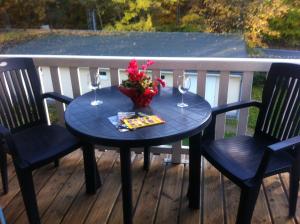 a table with wine glasses and flowers on a deck at Ostseeerlebnis in Graal-Müritz