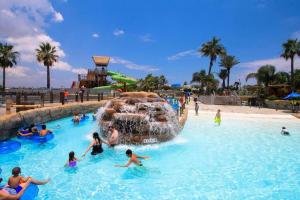 a group of people in a pool at a water park at The Sealy House in Galveston
