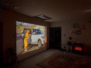 a room with a painting of a car on a wall at AMP FLAT Ogokusou in Fukuoka