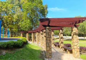 a stone pavilion with benches in a park at Comfy Park View Stay Above DPulze Mall #DP4 in Cyberjaya