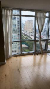 an empty room with a large window with a view of a city at A lovely - 1 bedroom condo with swimming pool in Toronto
