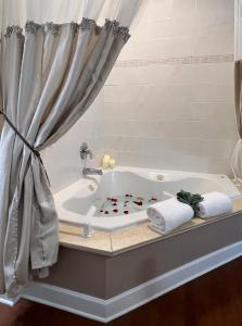 a bathroom with a tub with two towels at Victorian House Bed and Breakfast in Saint Augustine