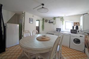 a kitchen with a table and chairs in a kitchen at Chambre 4, calme, 1 station de PARIS in Maisons-Alfort +8 photos