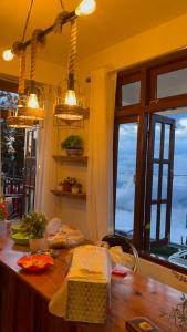 a kitchen with a wooden counter with a window at EJ’s Frontyard- The Home Cafe & Stay in Kurseong
