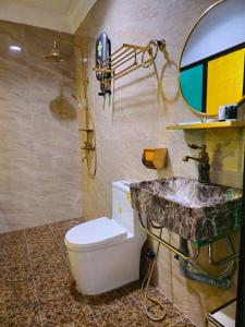 a bathroom with a sink and a toilet and a mirror at 乔治市世纪酒店 The Century Boutique Hotel George Town in George Town