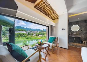 张家界Riverside Peak Lodge Zhangjiajie Wulingyuan National Park的客厅设有美景大窗户
