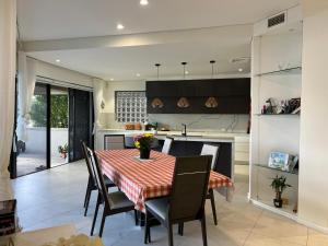 a kitchen and dining room with a table and chairs at Water Front House in Sydney