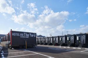 a row of train cars parked in a parking lot at HOTEL R9 The Yard 長浜 in Nagahama