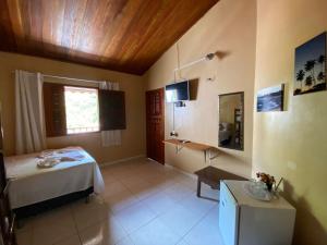 a room with a bed and a table in it at Apartamento Florence in Jericoacoara +2 photos